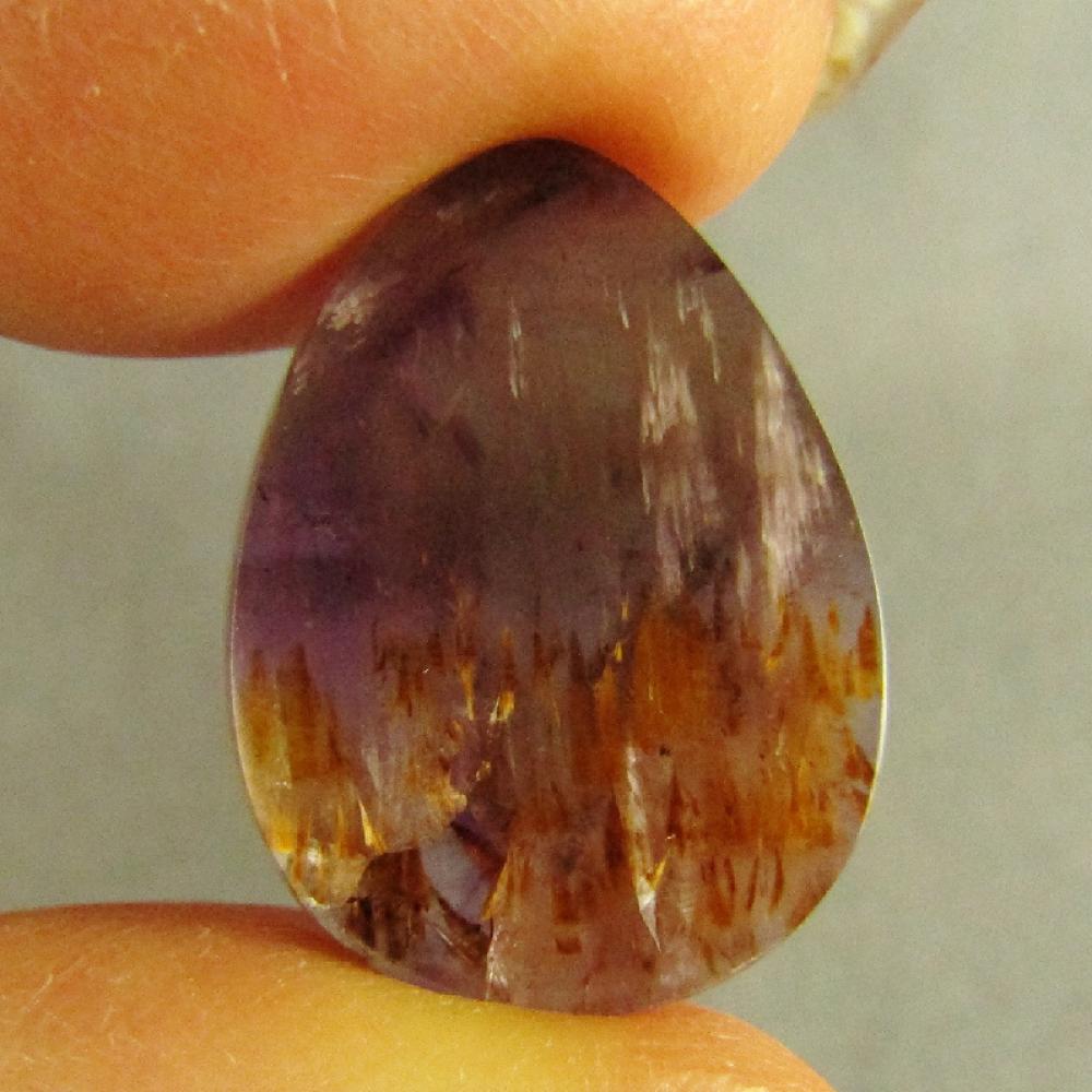 Cacoxenite in Amethyst Cabochon